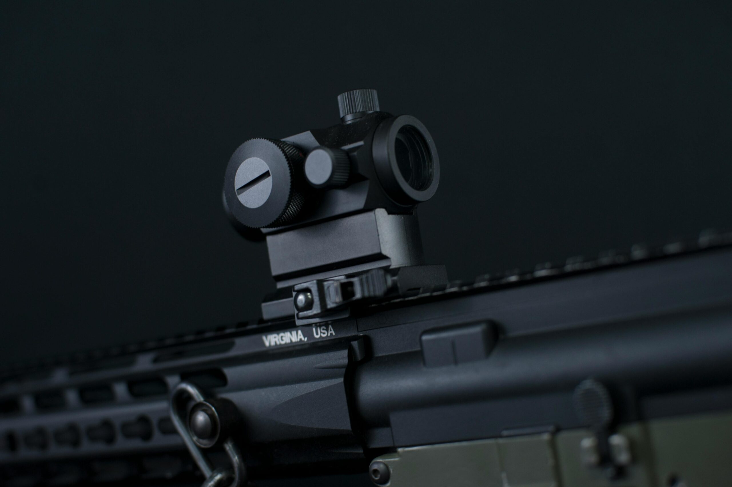 High-resolution close-up of a tactical firearm featuring an advanced targeting scope.